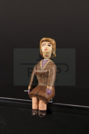 Seated female passenger miniature figure