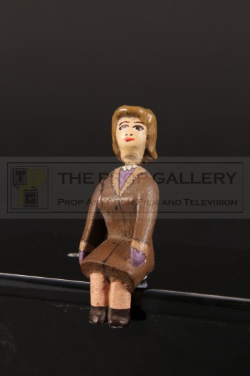 Seated female passenger miniature figure