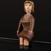 Seated female passenger miniature figure