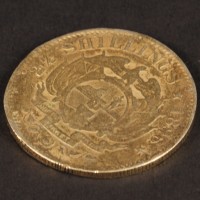 Van Pelt (Jonathan Hyde) gold coin