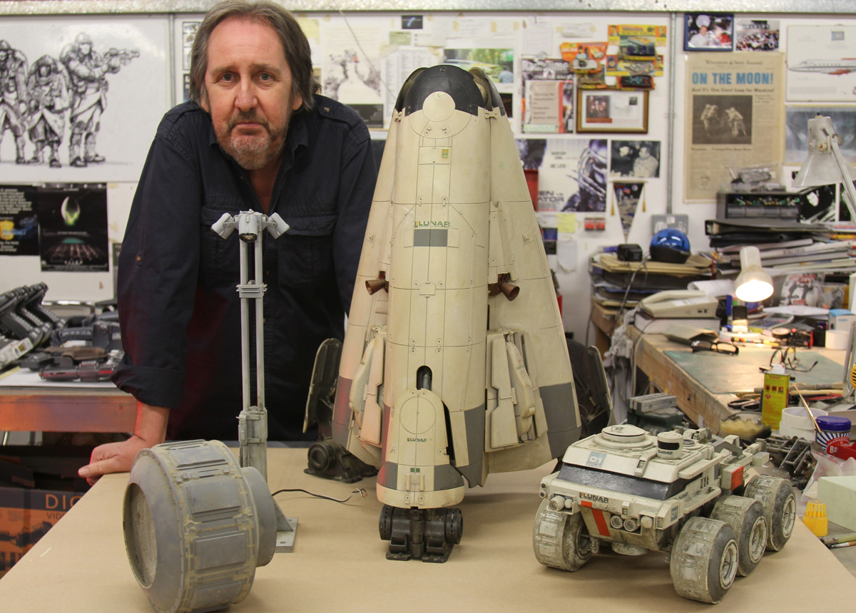 Bill Pearson poses with a number of the original miniatures from Moon