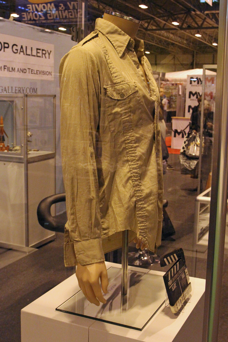 The Prop Gallery's original Indiana Jones shirt worn by Harrison Ford in Raiders of the Lost Ark, accompanied by a production used clapperboard.